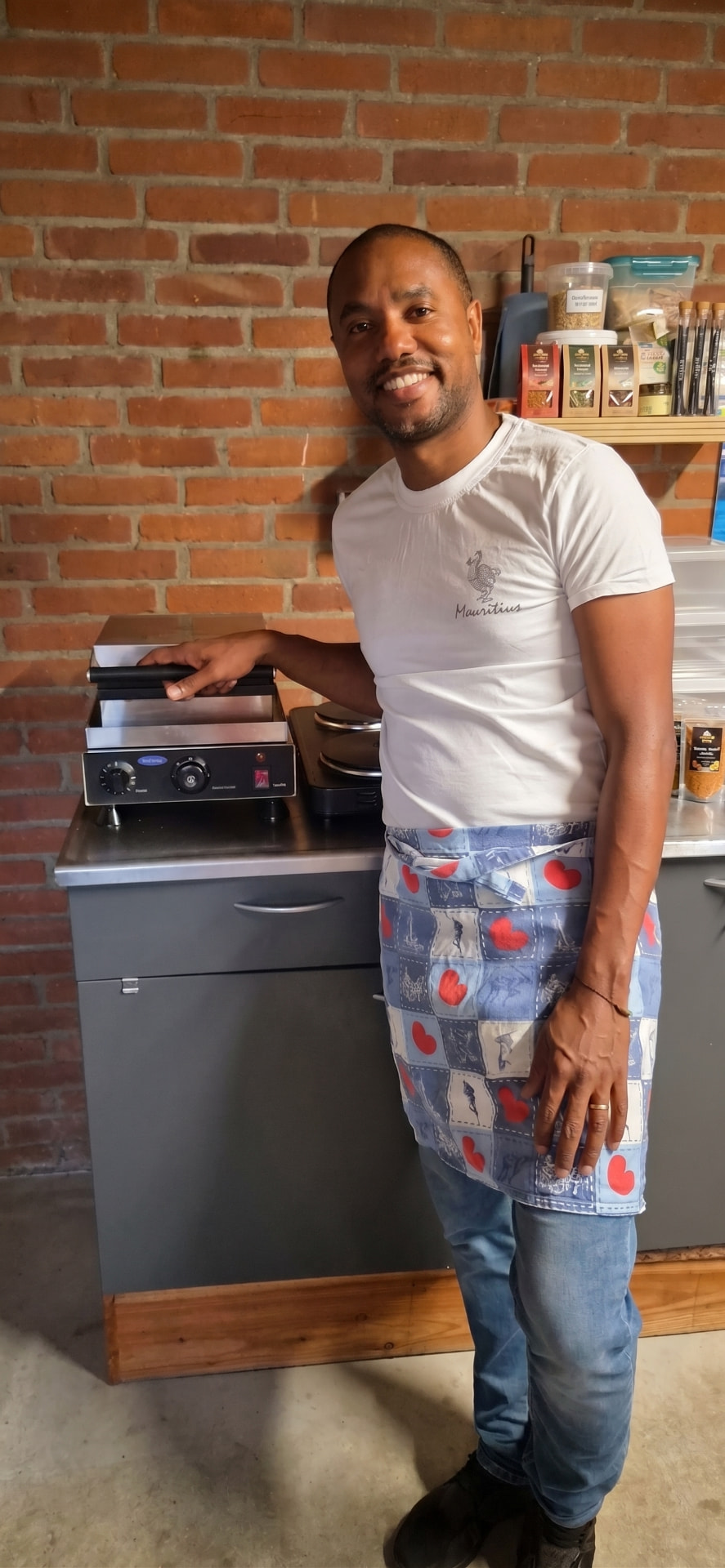 Winley beside the stroopwafel iron while developing the Dodo Wafel product